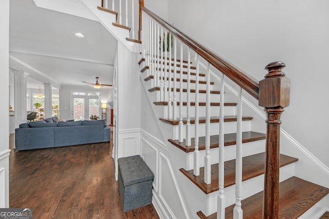 stairs with ceiling fan, wood-type flooring, and decorative columns