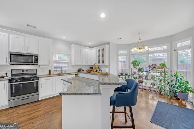 kitchen featuring white cabinetry, appliances with stainless steel finishes, and a kitchen island