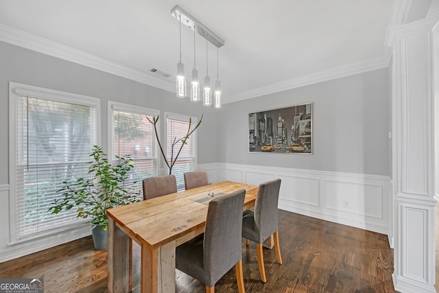 dining area featuring ornamental molding and dark hardwood / wood-style flooring