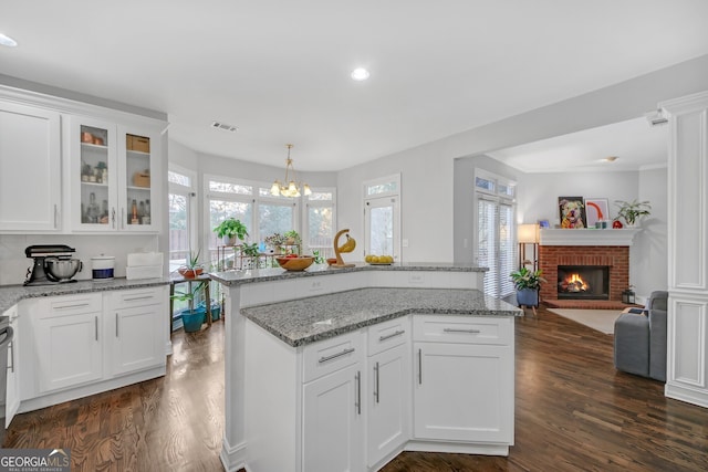 kitchen featuring white cabinetry, dark hardwood / wood-style floors, and pendant lighting