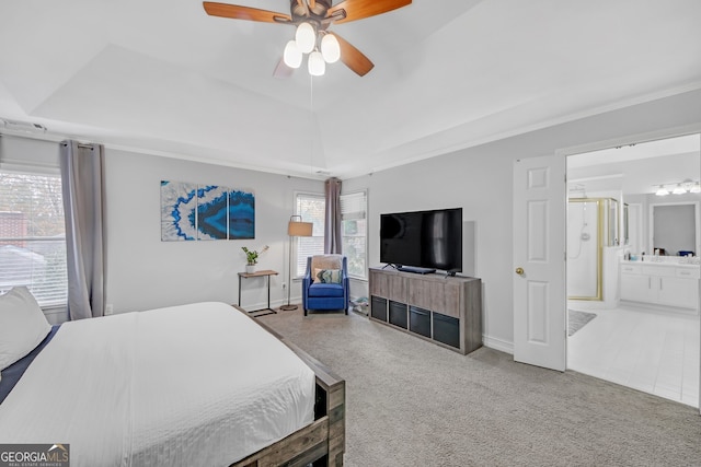 bedroom featuring ensuite bathroom, lofted ceiling, a raised ceiling, and carpet floors