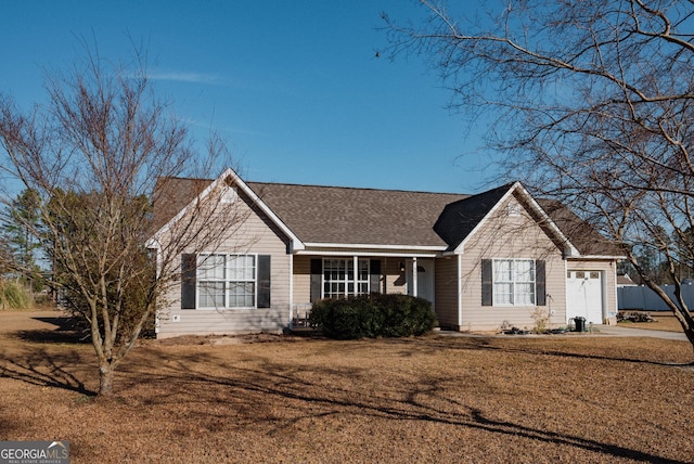 single story home featuring a garage and a front yard