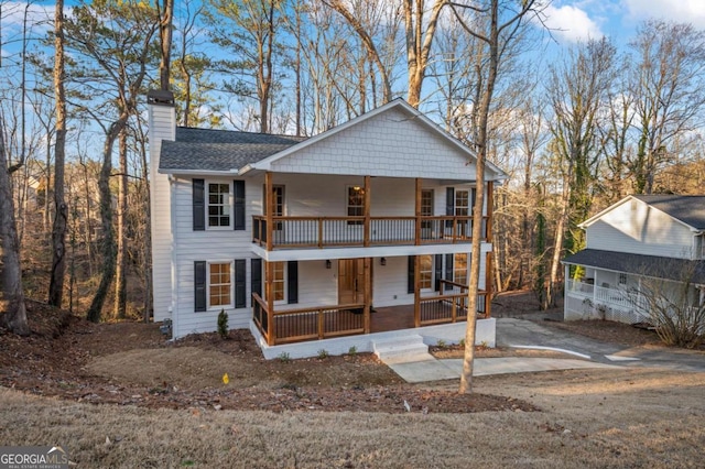 view of front facade with a balcony and covered porch