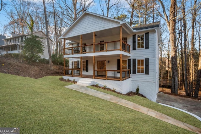 view of front of home featuring a front lawn, a balcony, and covered porch