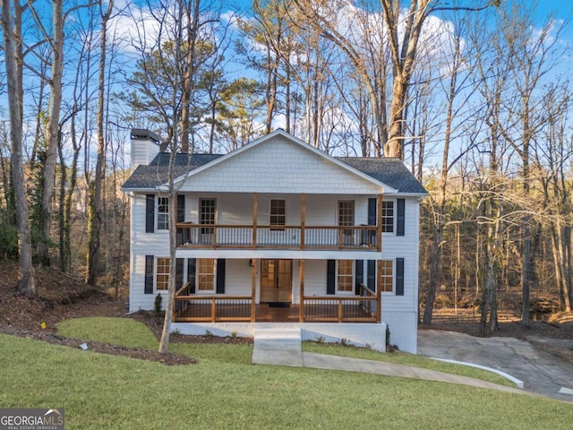 view of front facade with a front yard and a porch