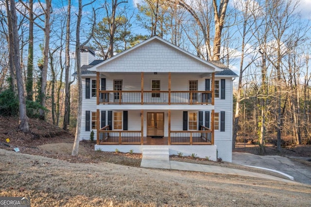 view of front of house with a balcony and covered porch