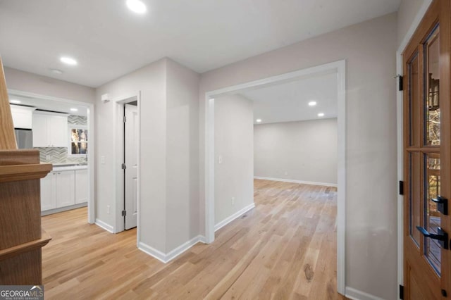 hall with light hardwood / wood-style flooring