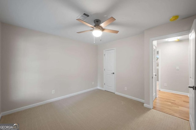 unfurnished bedroom featuring ceiling fan and light carpet