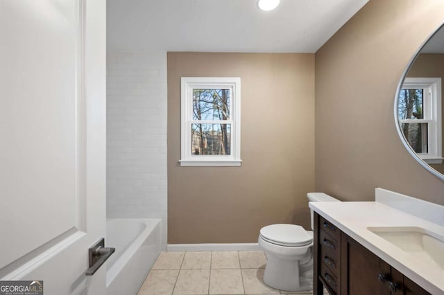 bathroom featuring tile patterned flooring, vanity, a washtub, and toilet