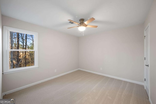 unfurnished room featuring ceiling fan and light carpet