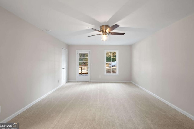 spare room with light colored carpet and ceiling fan