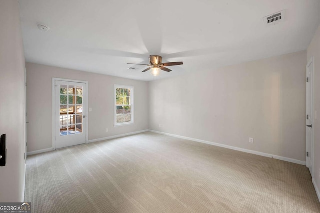 empty room with light colored carpet and ceiling fan