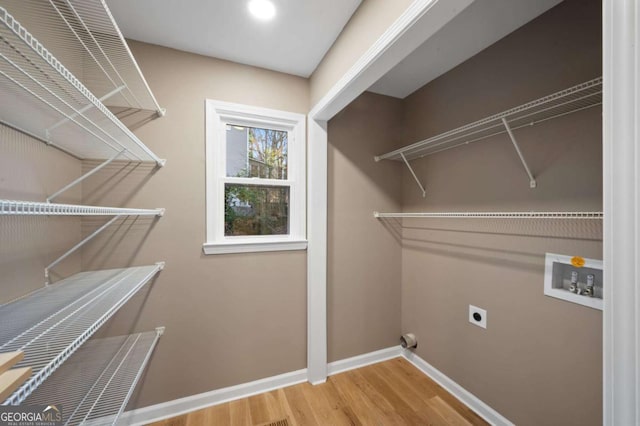 laundry room with wood-type flooring, electric dryer hookup, and washer hookup