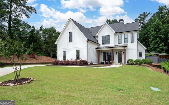 modern farmhouse with covered porch and a front lawn