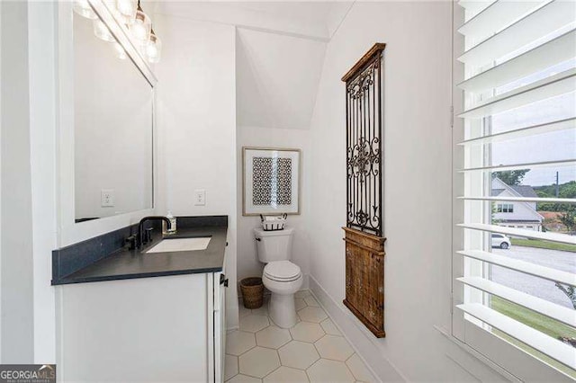 bathroom featuring vanity, tile patterned floors, and toilet