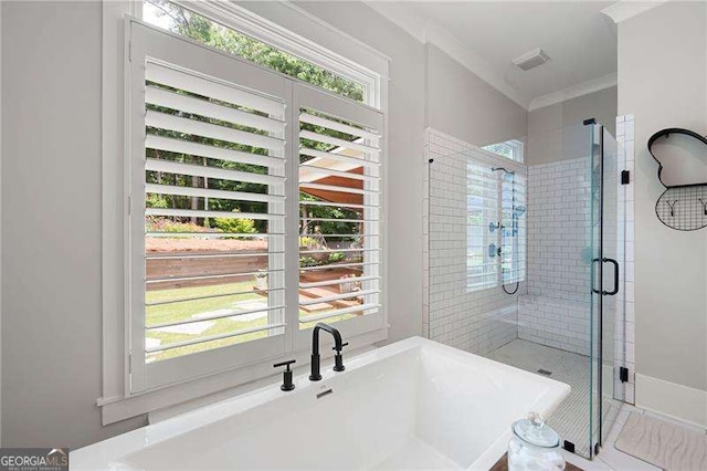 bathroom featuring crown molding and shower with separate bathtub