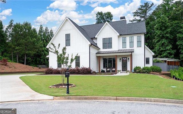 modern inspired farmhouse featuring a porch and a front lawn