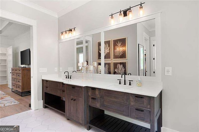 bathroom featuring ornamental molding and vanity