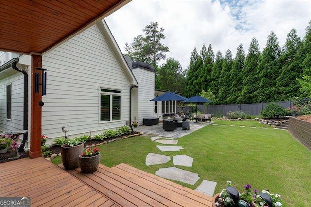 deck featuring a yard, an outdoor hangout area, and a patio area