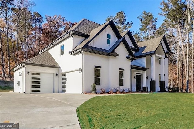 view of front of house with a garage and a front lawn