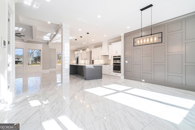 kitchen featuring marble finish floor, open floor plan, stainless steel appliances, and recessed lighting