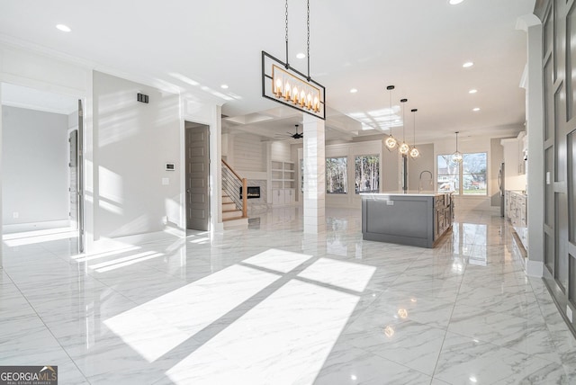 interior space with marble finish floor, decorative columns, ceiling fan with notable chandelier, and recessed lighting