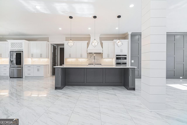 kitchen featuring marble finish floor, appliances with stainless steel finishes, custom exhaust hood, and light countertops