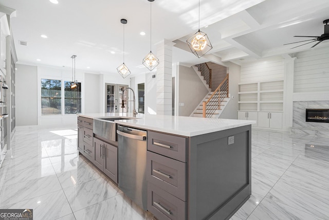 kitchen with marble finish floor, stainless steel appliances, gray cabinets, open floor plan, and a sink