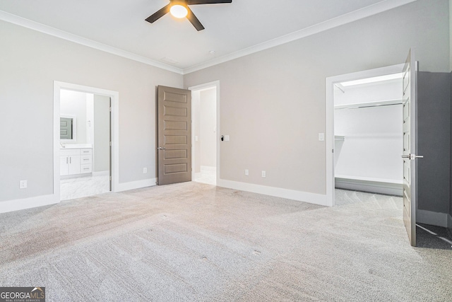 unfurnished bedroom with carpet flooring, crown molding, baseboards, and ensuite bathroom