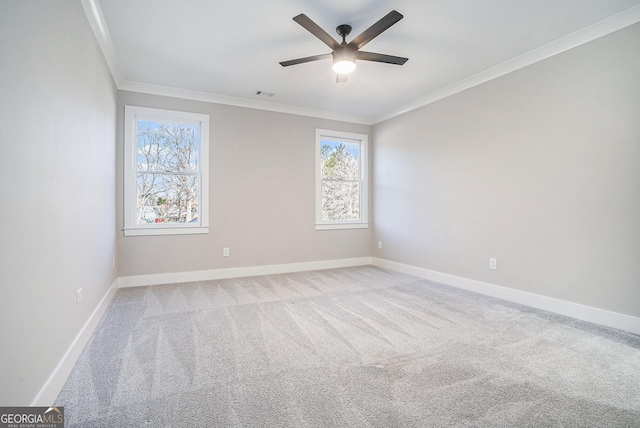 empty room featuring visible vents, baseboards, crown molding, and light colored carpet