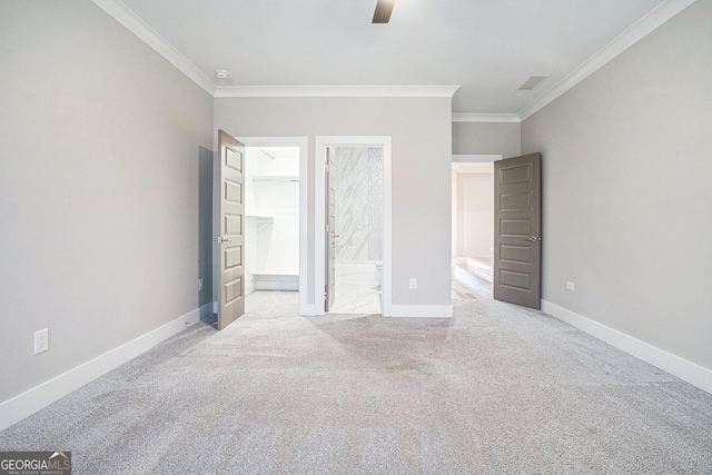 unfurnished bedroom with connected bathroom, visible vents, baseboards, ornamental molding, and carpet