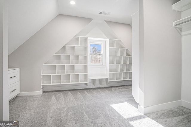 additional living space featuring carpet flooring, vaulted ceiling, visible vents, and baseboards