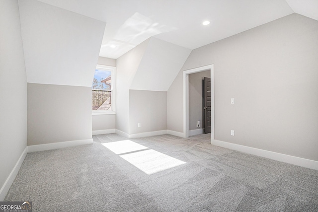 additional living space with lofted ceiling, light carpet, baseboards, and recessed lighting