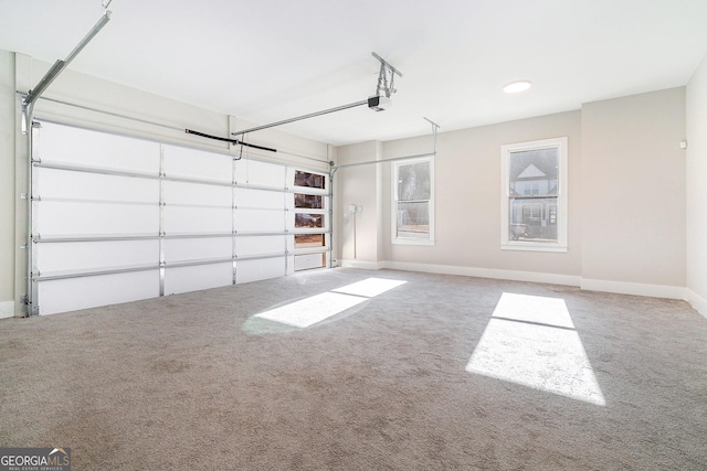 garage with baseboards and a garage door opener