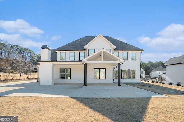 modern inspired farmhouse featuring a patio area, fence, and a front yard