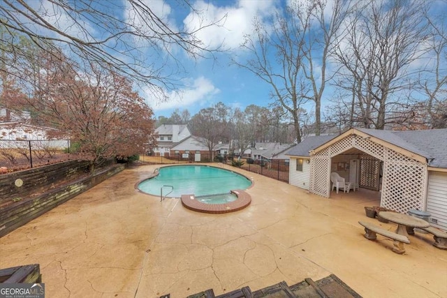 view of swimming pool featuring a patio and an in ground hot tub