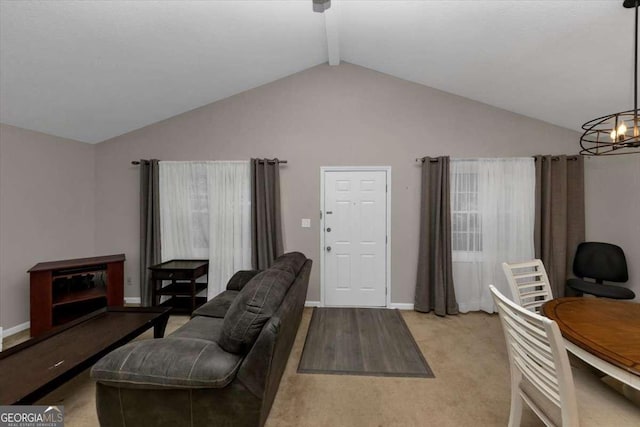 living room featuring lofted ceiling with beams and a chandelier