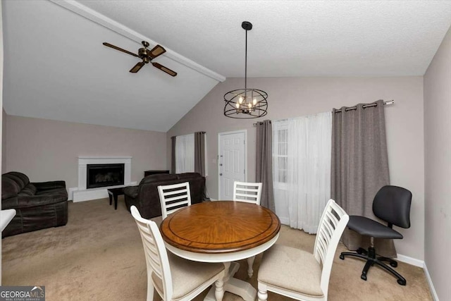 dining space featuring ceiling fan with notable chandelier, lofted ceiling with beams, light carpet, and a textured ceiling