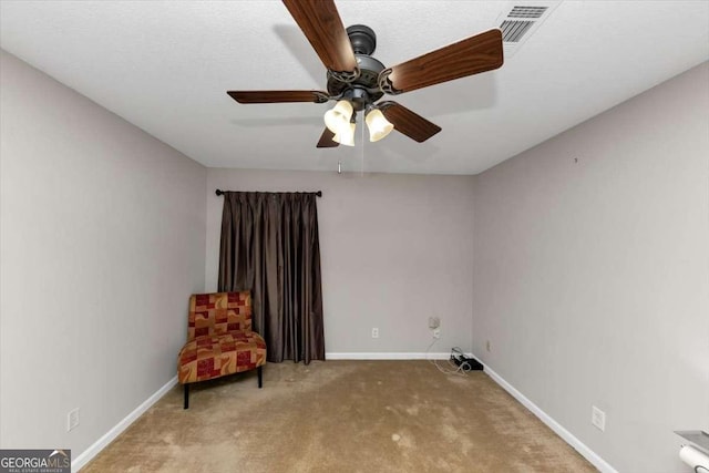 unfurnished room featuring ceiling fan and light carpet