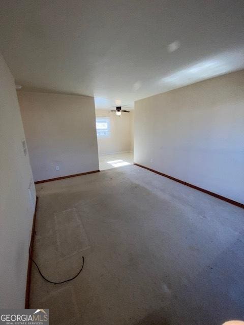 unfurnished room with ceiling fan and carpet flooring