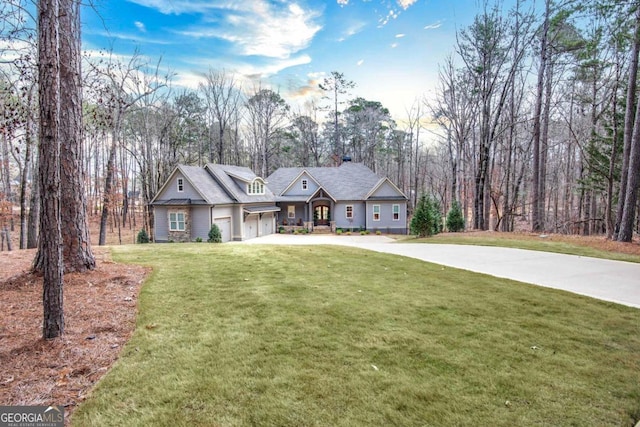 view of front of house with a garage and a front lawn