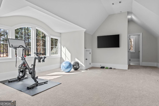 exercise area featuring vaulted ceiling and carpet