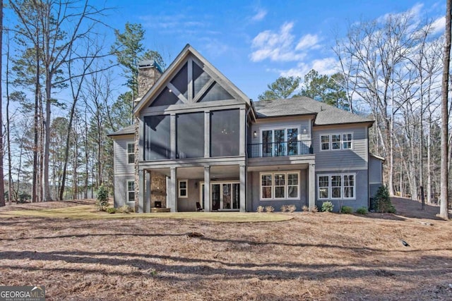 back of property with a sunroom