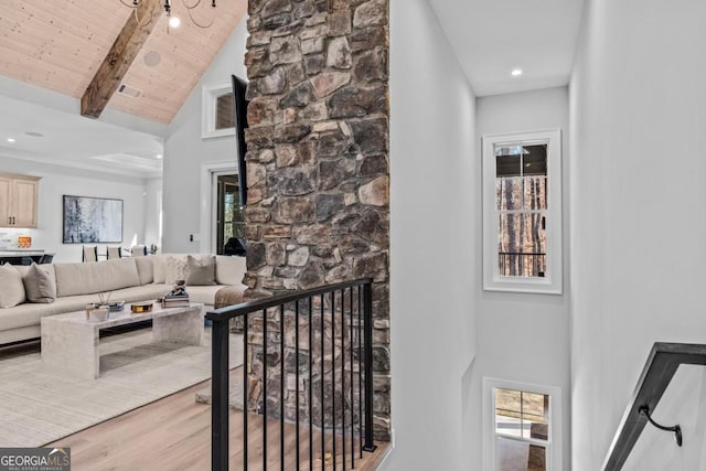 hall featuring wood ceiling, wood-type flooring, beam ceiling, and high vaulted ceiling