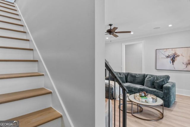 staircase featuring hardwood / wood-style flooring and ceiling fan