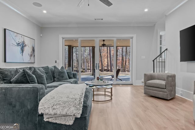 living room featuring crown molding, ceiling fan, and wood-type flooring