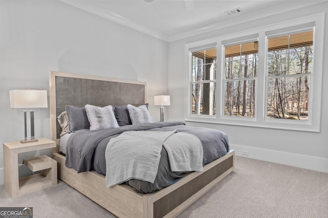 carpeted bedroom featuring crown molding