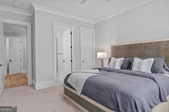 carpeted bedroom featuring crown molding and ensuite bath