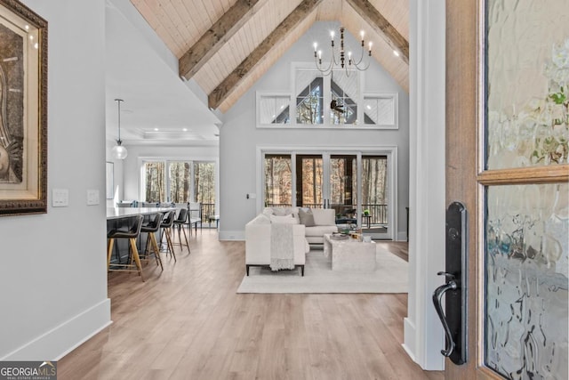 interior space with high vaulted ceiling, beamed ceiling, a chandelier, wood ceiling, and light hardwood / wood-style flooring