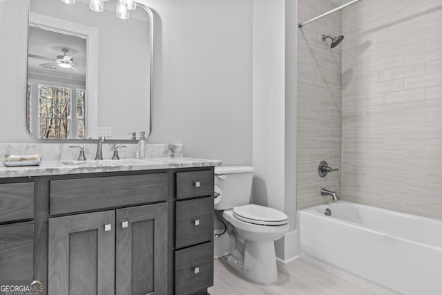 full bathroom with vanity, toilet, and tiled shower / bath